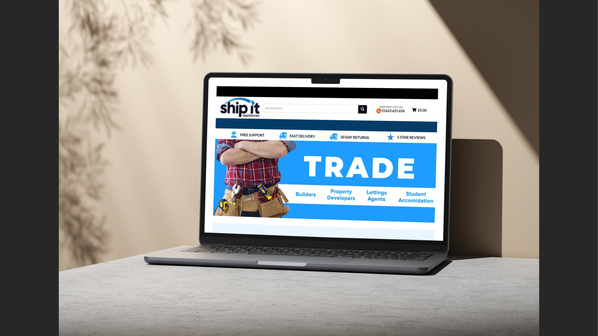 Screenshot of the Ship It Appliances website on a laptop, displaying a bold “TRADE” banner featuring a person in a red check shirt and tool belt. The navigation bar highlights key services like free support, fast delivery, and five-star reviews. Trade customer categories such as Builders, Property Developers, Lettings Agents, and Student Accommodation are listed below the banner.